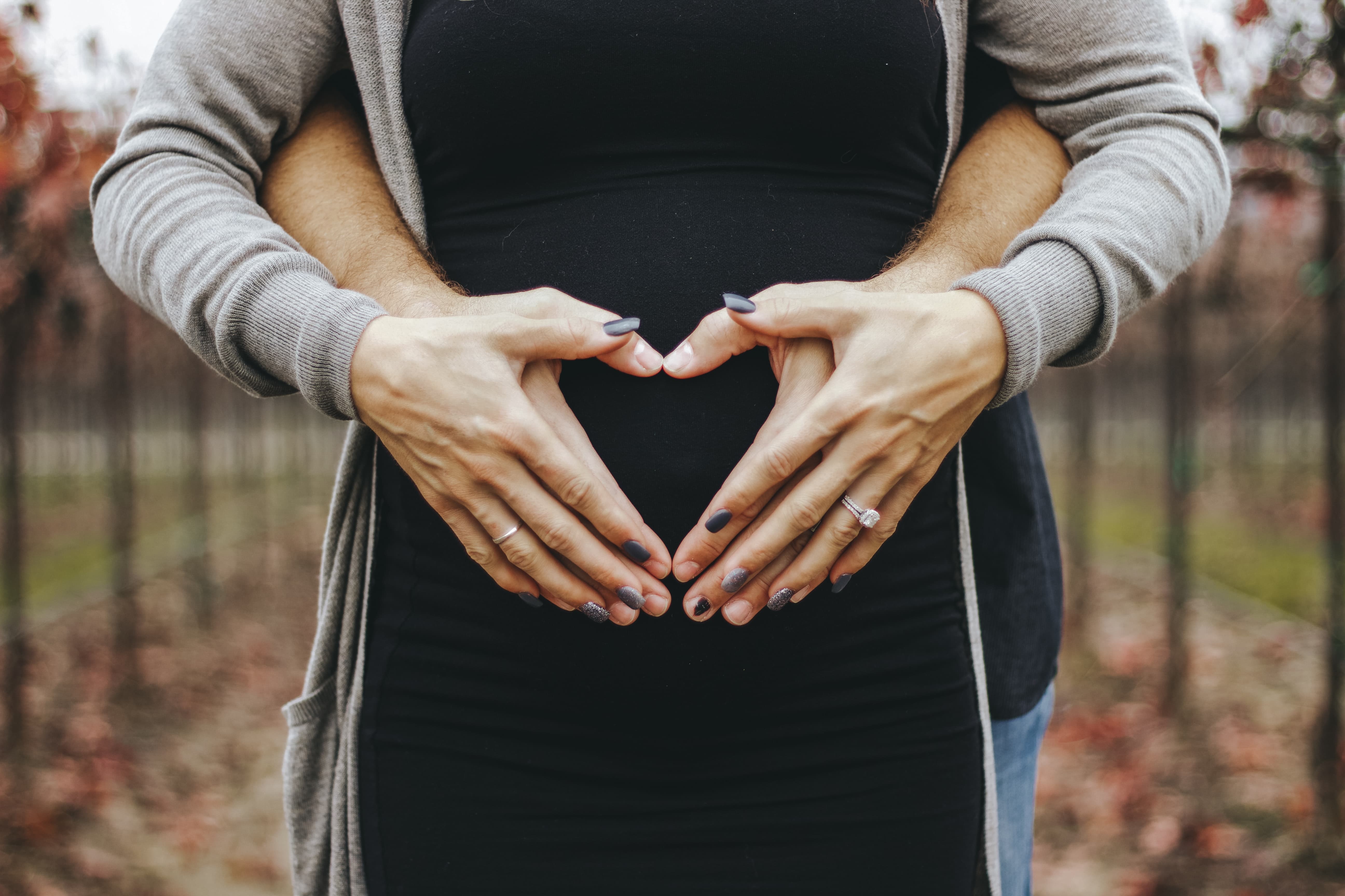 Couple holding baby belly